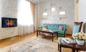 a living room with a green couch and a table at Large EuApartments in Grodno