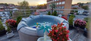 a hot tub sitting on a balcony with flowers at Villa Radica in Negotino