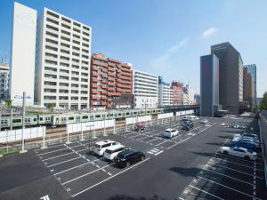 a parking lot with a train in a city at Hotel Bellclassic Tokyo in Tokyo