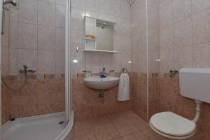 a bathroom with a shower and a sink and a toilet at Apartments Bella Sky V in Novalja +60 photos