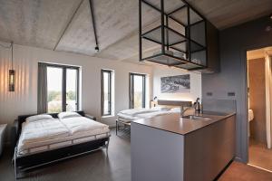 a kitchen with two beds and a sink in a room at Zleep Hotel Lyngby in Kongens Lyngby