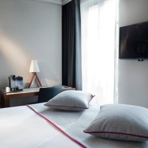 Кровать или кровати в номере Hotel Saint Dominique