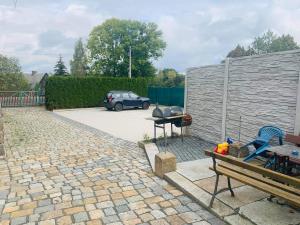 a patio with a car parked in a parking lot at Penzion u Laštůvků in Šluknov