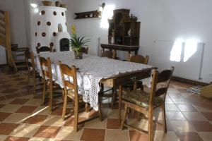 a dining room with a table and chairs at Faluszéli Vendégház - Boncz Porta in Nagyrákos