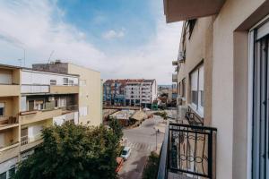 a view of a city street from a balcony at Republic Square Apartment - with garage in Novi Sad