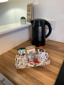 a tray with a coffee pot and cups on a counter at Durham Serviced Properties - The Sanctuary in Durham