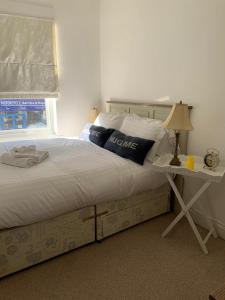 a bedroom with a bed and a table with a lamp at Durham Serviced Properties - The Sanctuary in Durham