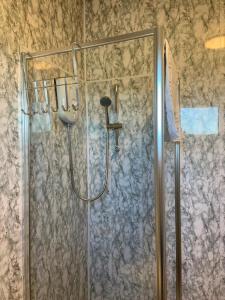 a shower with a glass door in a bathroom at Durham Serviced Properties - The Sanctuary in Durham