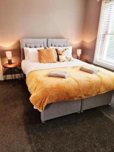 a bedroom with a large bed with two pillows on it at Royal Victoria House in Dundee