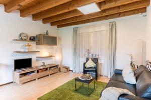 a living room with a couch and a tv at Appartement Böhler 2 in Reichenau