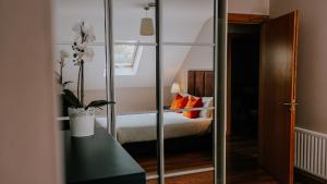 a room with a bed, a mirror, and a dresser at Five Lamps Suites in Dublin