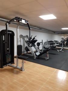 a gym with several tread machines in a room at Taina La Envia Golf in La Envia