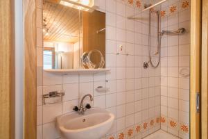 y baño con lavabo y ducha. en Försterhaus Wohnung Obergeschoss, en Egg