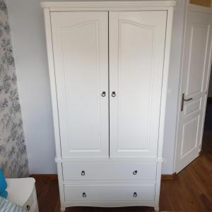 a white cabinet with two doors in a room at The Alpaca B&B in Chaleix