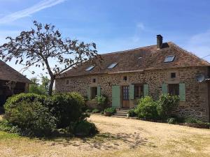 an old stone house with a tree in front of it at The Alpaca B&B in Chaleix