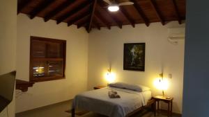 a bedroom with two beds and two lights at Bangalôs Parque Verde in Paraty