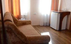 a living room with a couch and a refrigerator at Hotel Imperial 2011 in Yalta