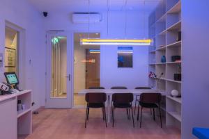 a dining room with a table and black chairs at 171. Urban Design Hotel in Rotterdam