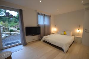 a bedroom with a bed and a large window at La Chambre #11 in Preverenges