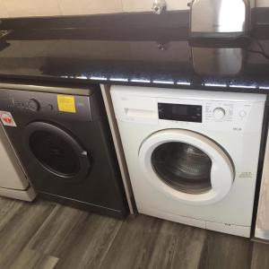 a washing machine and a dryer in a kitchen at Villa Siesta Flat No 1 in Margate