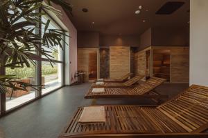 a row of benches in a room with windows at Hotel Grof in Vransko