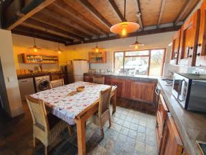 a kitchen with a table with chairs and a microwave at Hadeda Lodge, Mabalingwe in Warmbaths