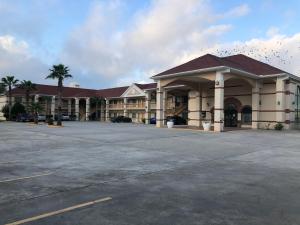 a large building with a parking lot in front of it at Porter Executive Inn & Suites in Porter