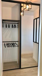 a walk in closet with a glass door at Sea view - Promenade des Anglais in Nice
