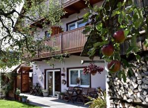 a house with a balcony and a patio at Rooms Ravnik in Bled