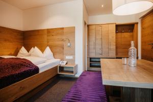 a hotel room with a bed and a desk at Alpina Wagrain in Wagrain