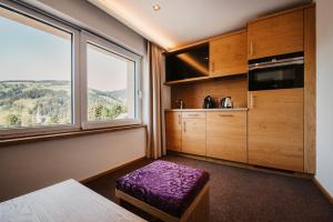 a room with a kitchen with a large window at Alpina Wagrain in Wagrain +100 photos