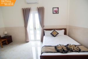 Postel nebo postele na pokoji v ubytování Magnolia Hotel Cam Ranh