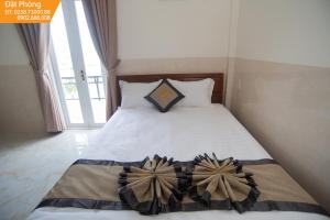 Postel nebo postele na pokoji v ubytování Magnolia Hotel Cam Ranh