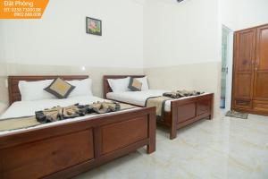 Postel nebo postele na pokoji v ubytování Magnolia Hotel Cam Ranh