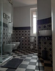 a bathroom with two sinks and a glass shower at VILLA ADRIANA in Bra