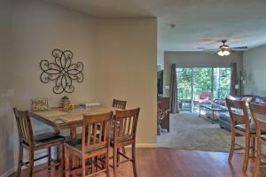 a dining room and living room with a table and chairs at Resort Condo with Patio, 5 Mi to Branson Landing! in Branson