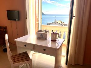 a table in front of a window with a view of the ocean at Hotel La Giara in Recco