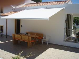 a white canopy over a table and a bench at Wonderful Skiathos Villa Two Bedroom Villa Parisis Short Walk to Beachl Troulos in Troulos