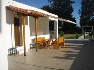 a pavilion with a table and a bench on a patio at Wonderful Skiathos Villa Two Bedroom Villa Parisis Short Walk to Beachl Troulos in Troulos