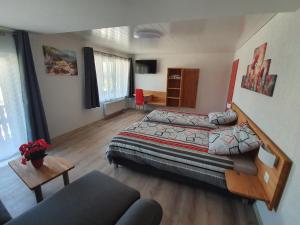 een slaapkamer met een bed en een woonkamer bij Gasthof Schwanen Radelfingen in Radelfingen