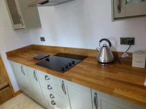 a kitchen with a counter top with a tea kettle at THE CHAPEL 