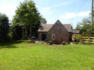 a brick house in a yard with a green lawn at THE CHAPEL 