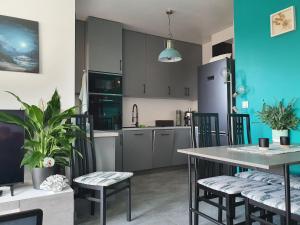 a kitchen with a table and chairs and a refrigerator at Meerblick - widok na morze in Puck