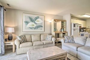 a living room with two couches and a table at Ocean City Condo with Pool - Steps to Beach! in Ocean City
