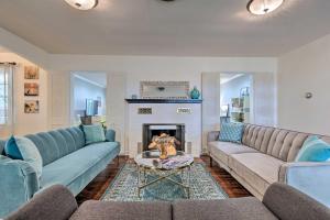 a living room with two couches and a fireplace at Ocean Springs Home - Walk to Beach and Downtown! in Ocean Springs