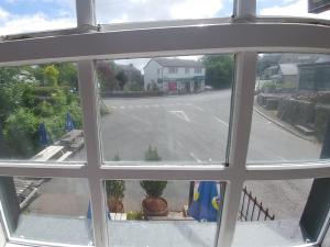 a view of a street from an open window at The Engine Inn in Holker