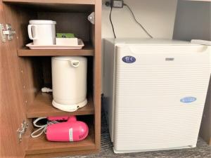 a room with a refrigerator and a coffee maker at BANDE HOTEL OSAKA - Vacation STAY 98159 in Osaka