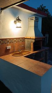 a kitchen counter with a sink and a light at Alojamiento Rural El Paraíso del Chorro in El Chorro
