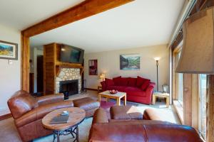 a living room with leather furniture and a fireplace at Anaconda 103 in Copper Mountain