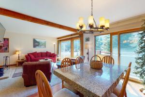 a living room with a table and a couch at Anaconda 103 in Copper Mountain
